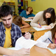 Small children and teenagers alike take the new comprehensive exam, which is now the entirety of the American educational system.